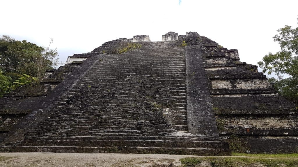 The Sloping Panel temple temple at Tikal has a clear architectural influence from Teotihuacan. It is not as high as some of the other pyramids but has a wider base, creating a gentler incline to the top