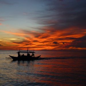 Fishing boat with setting sunset sky behind, Boracay Philippines