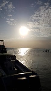 Early morning sun leaving Caye Culker Belize on a water taxi