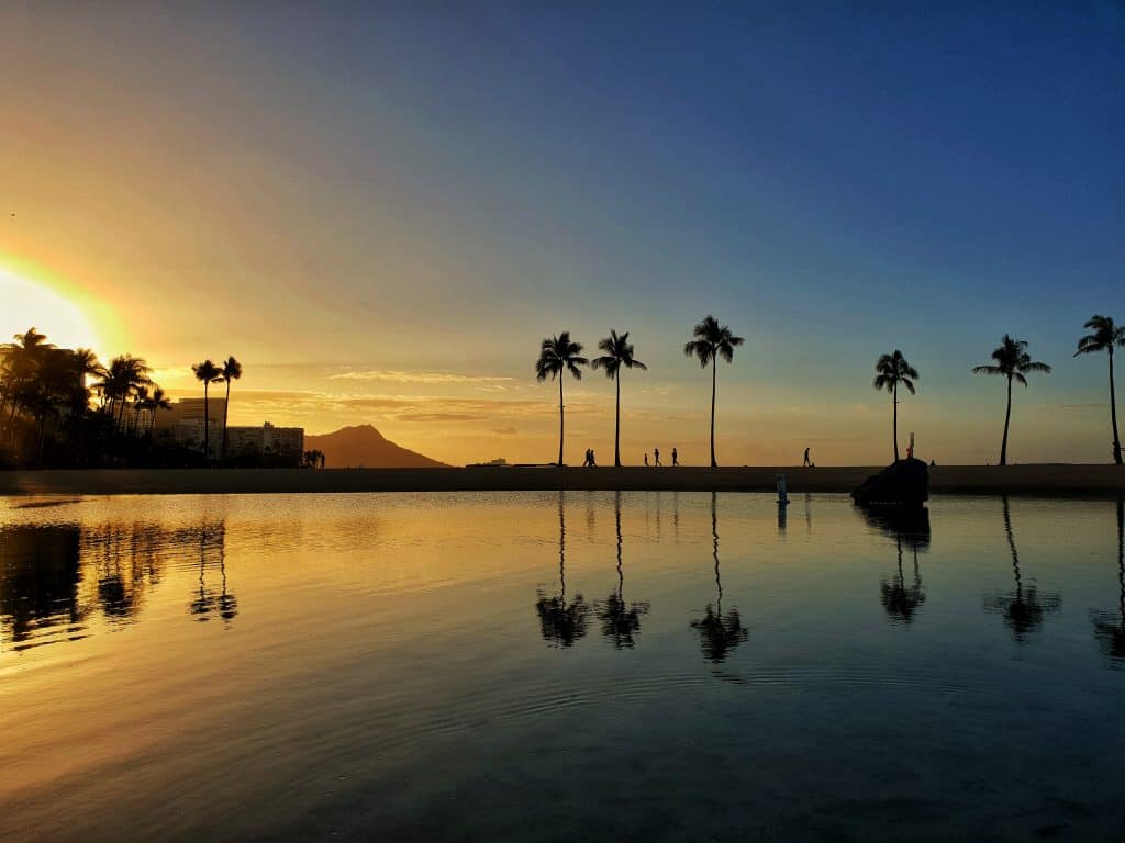 Reflection of sunrise on lagoon at Hilton Hawaiian Village