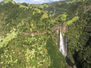 Waterfall in Kauai from a helicopter by Nikki from She Saves She Travels