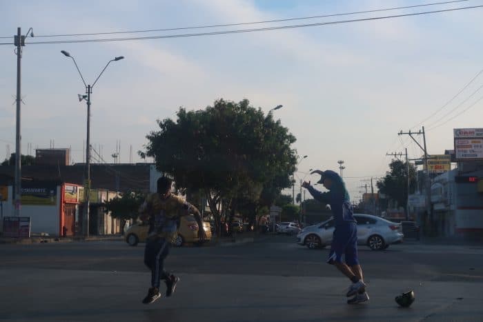 Children dancing in the street in Colombia. Courtesy of Layer Culture