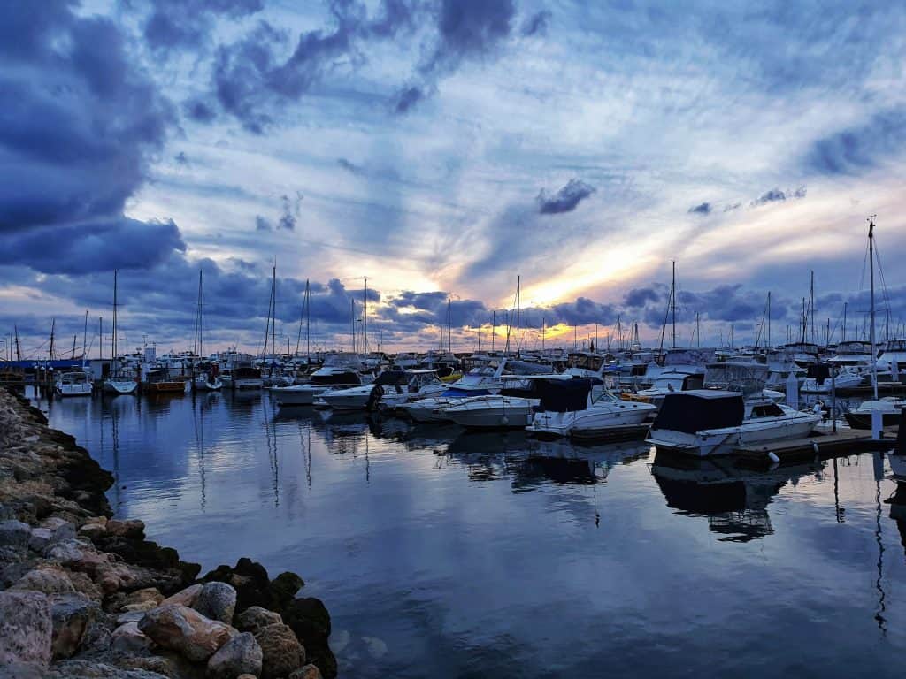 Sun sinking over the horizon from Hilary's Boat Harbour in Perth, Western Australia